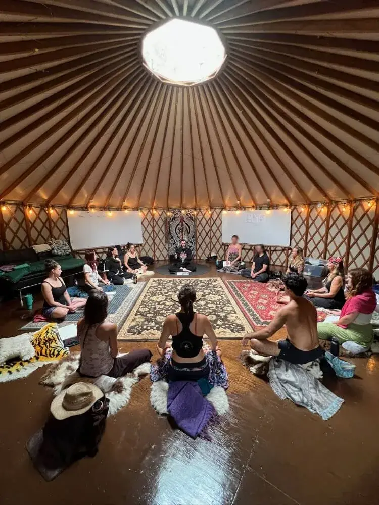 Yogis in a circle inside a yurt for INO discussion by Sri Vijayanath